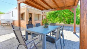 a blue table and chairs on a patio at Casa Huerta Alejo Alozaina by Ruralidays in Alozaina