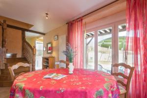 a dining room with a table with a vase on it at La Villanelle 