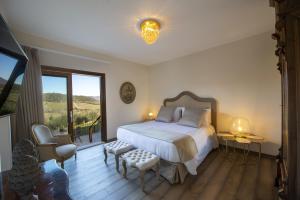 a bedroom with a bed and a large window at Villa il Giardino - Homelike Villas in Greve in Chianti +14 photos