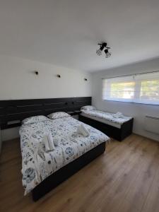 a bedroom with two beds and a window at Apartment Dado in Slunj