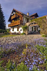 a house with a bunch of flowers in front of it at Willa Krokus in Miedzygorze