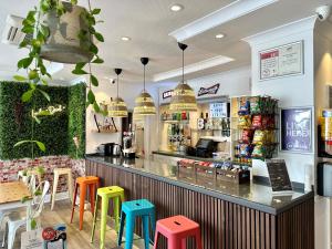 a restaurant with colorful stools in front of a counter at Smart Hyde Park View Hostel in London