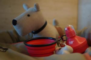a toy teddy bear holding a red cup with a baby bottle at Hotel Espanya by ALEGRIA in Calella