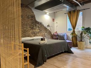 een slaapkamer met een bed en een bakstenen muur bij Luxury Apartment Stancesvic LOFT (New) in Vic
