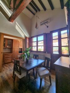 a dining room with a wooden table and chairs at Upper Garden Guest House in Cagliari