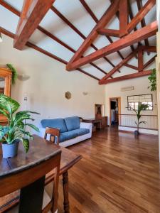 a living room with a blue couch and wooden floors at Upper Garden Guest House in Cagliari