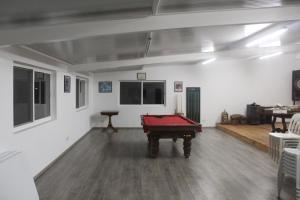 a room with a pool table in the middle of it at Quintinha do Poceirão in Águas de Moura