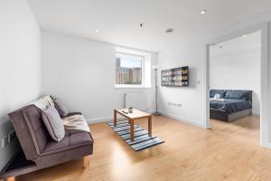 a living room with a couch and a table at London's Charm 2 BR Flat CB3 in Croydon