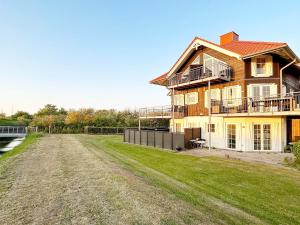 a large house on the side of a field at 8 person holiday home in Bogense-By Traum in Bogense
