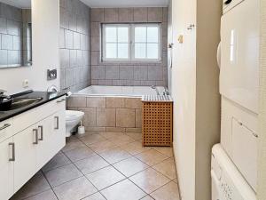 a bathroom with a tub and a toilet and a sink at 8 person holiday home in Bogense-By Traum in Bogense +34 photos