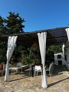a patio with a table and chairs under a canopy at trullo Giardino Sotto La Luna in Ceglie Messapica