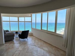 a living room with a view of the ocean at Sea-front apartment Netanya in Netanya