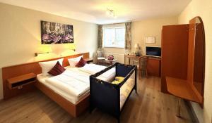 une chambre d'hôtel avec un lit et une télévision dans l'établissement Landhotel Vessens Hoff, à Buchholz in der Nordheide