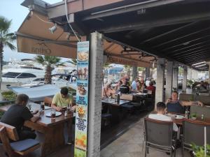 a group of people sitting at tables at a restaurant at Dream Night Boats in Poreč