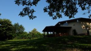 a house on the side of a grassy hill at Polani - Il Noceto in Cave