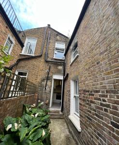 a brick building with a door and a window at Sterne Street in London