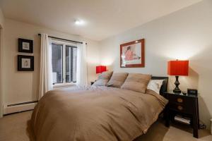 a bedroom with a large bed and a window at All Seasons Steps to Chairlift in Vail