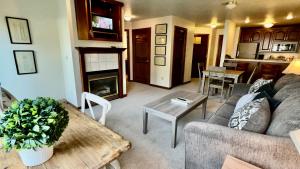 a living room with a couch and a table at Baileys Harbor Yacht Club Resort in Baileys Harbor