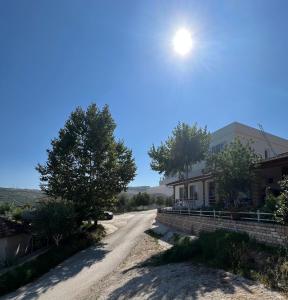 a dirt road in front of a house at Astoria Rooms in Sarandë