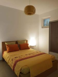 a bedroom with a large bed with orange pillows at Cosy 3 bedroom apartment calm and landscape view in Praia