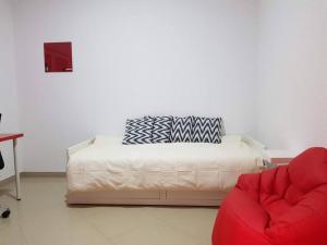 a bedroom with a bed and a red chair at Cosy 3 bedroom apartment calm and landscape view in Praia