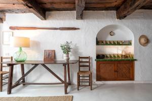 a dining room with a wooden table and chairs at Flateli Sa Tuna 4 in Begur
