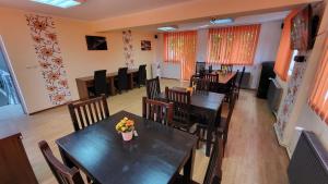 a dining room with tables and chairs in a restaurant at Boutique Global in Braşov