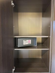 a small cabinet with a microwave in it at Comfortable Modern Apartment in Buenos Aires