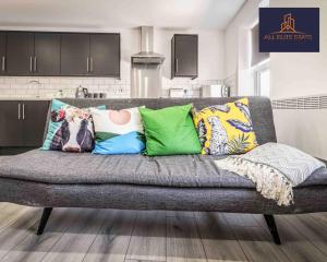 a couch with pillows on it in a living room at Swan House Apartment 7 - 2 Bed Apartment - Sleeps 5 - Free Parking - Liverpool - close to city centre - By ALL ELITE STAYS in Liverpool