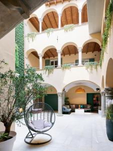 a courtyard with a bench in front of a building at ReGo Apartments in Bergamo