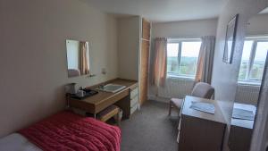 a hotel room with a sink and a bedroom at Cober Hill in Scarborough