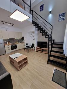 a living room with a staircase and a kitchen at SKG City Loft in Thessaloniki