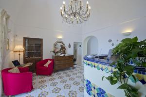 a living room filled with furniture and decor at Palazzo Talamo in Positano