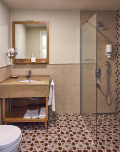 a bathroom with a sink and a shower at Meydani Butik Hotel in Gokceada Town