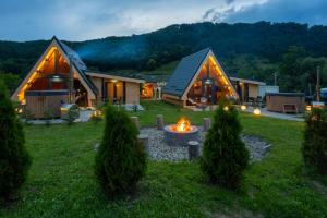 a home with a fire pit in the yard at Ungefug A-Frame Sighisoara in Sighişoara