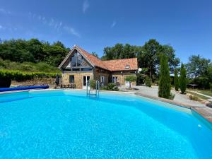 une grande piscine en face d'une maison dans l'établissement Maison De Lavende, à Bessines-sur-Gartempe
