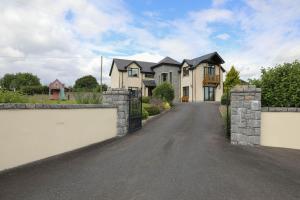 a large house with a gate and a driveway at Narrow water house in Dundalk