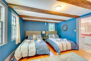 two beds in a room with blue walls at Franconia Home with Piano, Fire Pit and Community Pool in Franconia