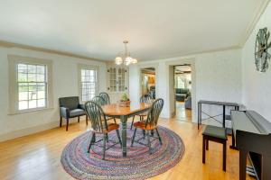 a dining room and living room with a table and chairs at Franconia Home with Piano, Fire Pit and Community Pool in Franconia
