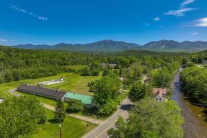 an aerial view of a farm with mountains in the background at Franconia Home with Piano, Fire Pit and Community Pool in Franconia
