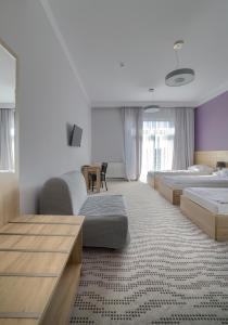 a large bedroom with two beds and a table at Nova Stodola in Kłomnice