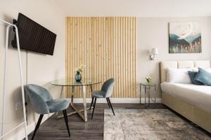 a room with a table and two chairs and a bed at Euston apartments in London