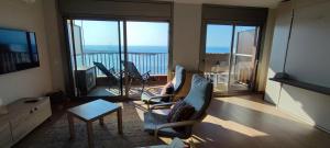a living room with chairs and a view of the ocean at LLOGUER30 Garbí Love, vistas espectaculares del mar in Sant Feliu de Guixols +22 photos