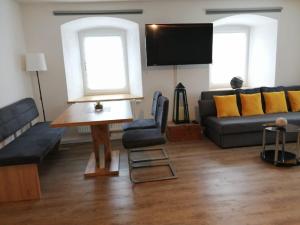 a living room with a couch and a tv at Apartments Haus Erna in Weitra