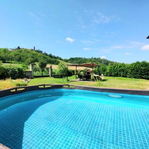 una piscina in un cortile con gazebo di La Dolce Vita a CastellʼAlfero