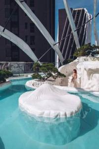 a woman in a wedding dress in a swimming pool at Arte Mont Kiara Studio Apartment Hartamas in Kuala Lumpur