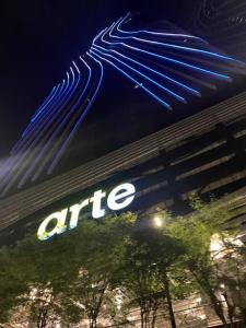 a sign on the side of a office building at night at Arte Mont Kiara Studio Apartment Hartamas in Kuala Lumpur