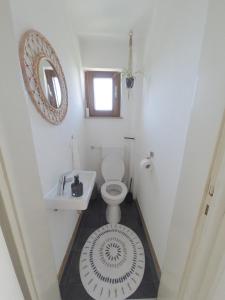 a bathroom with a toilet and a sink and a mirror at HappyBNB Apartment mit sonniger Terrasse in Löchgau