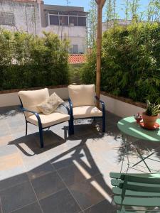 a patio with two chairs and a table at Aldeia de Portimão in Portimão