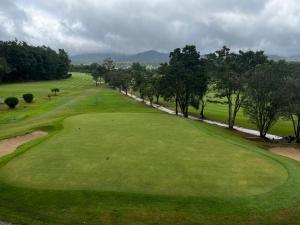 a view of the green on a golf course at La Paz Coorg homestay at Madikeri town in Madikeri